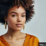 블랙헤어를 위한 스타일링 팁 - A close-up portrait of a young Black woman with natural, tightly coiled afro-textured hair styled in...